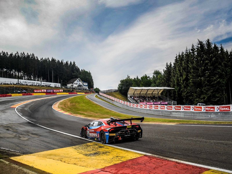 Lamborghini Huracan Super Trofeo EVO number 39 navigating a corner at Spa-Francorchamps with spectators in the grandstands