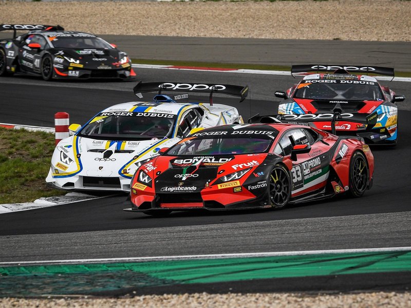 Multiple Lamborghini Huracán Super Trofeo EVO race cars battling on track with aggressive aero and racing liveries