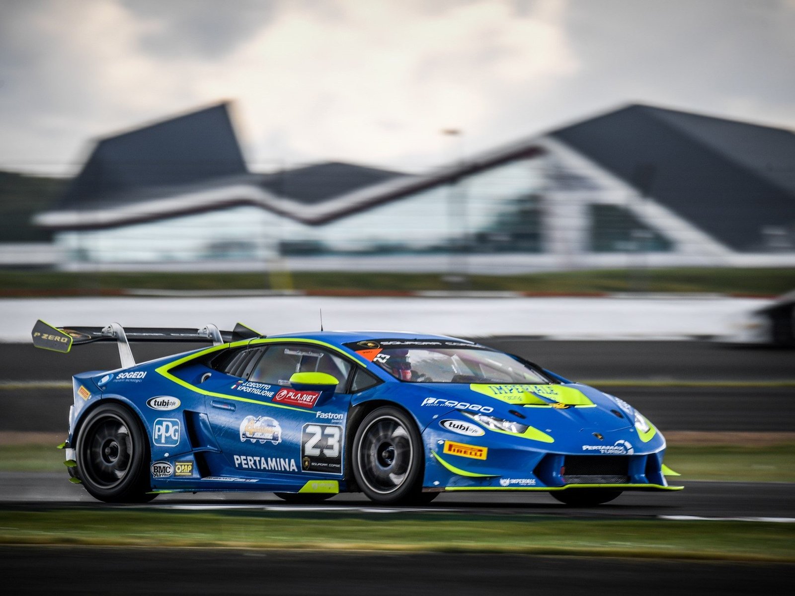 Blue and yellow Lamborghini Huracán Super Trofeo number 23 racing at Silverstone during the 2017 Super Trofeo Europe round