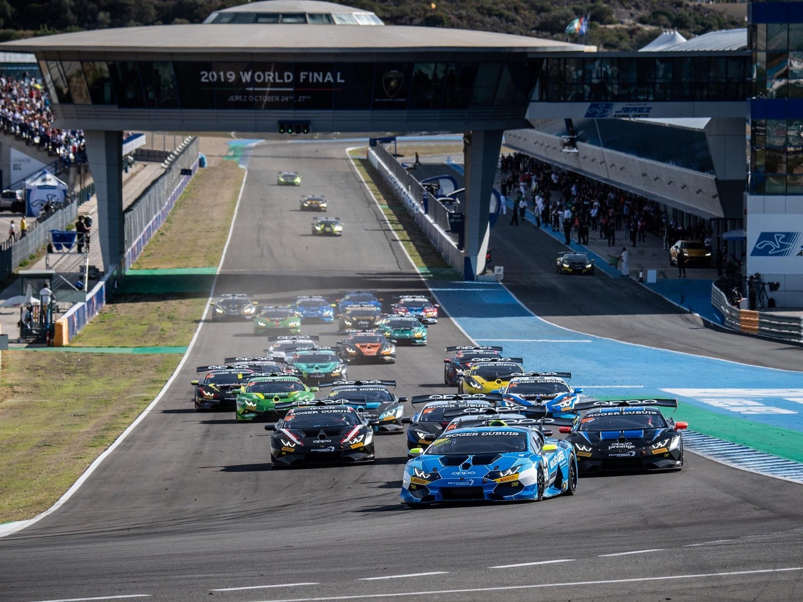 A packed grid of Lamborghini Huracán Super Trofeo Evo race cars battling on track at the Jerez de la Frontera circuit during the 2019 World Finals