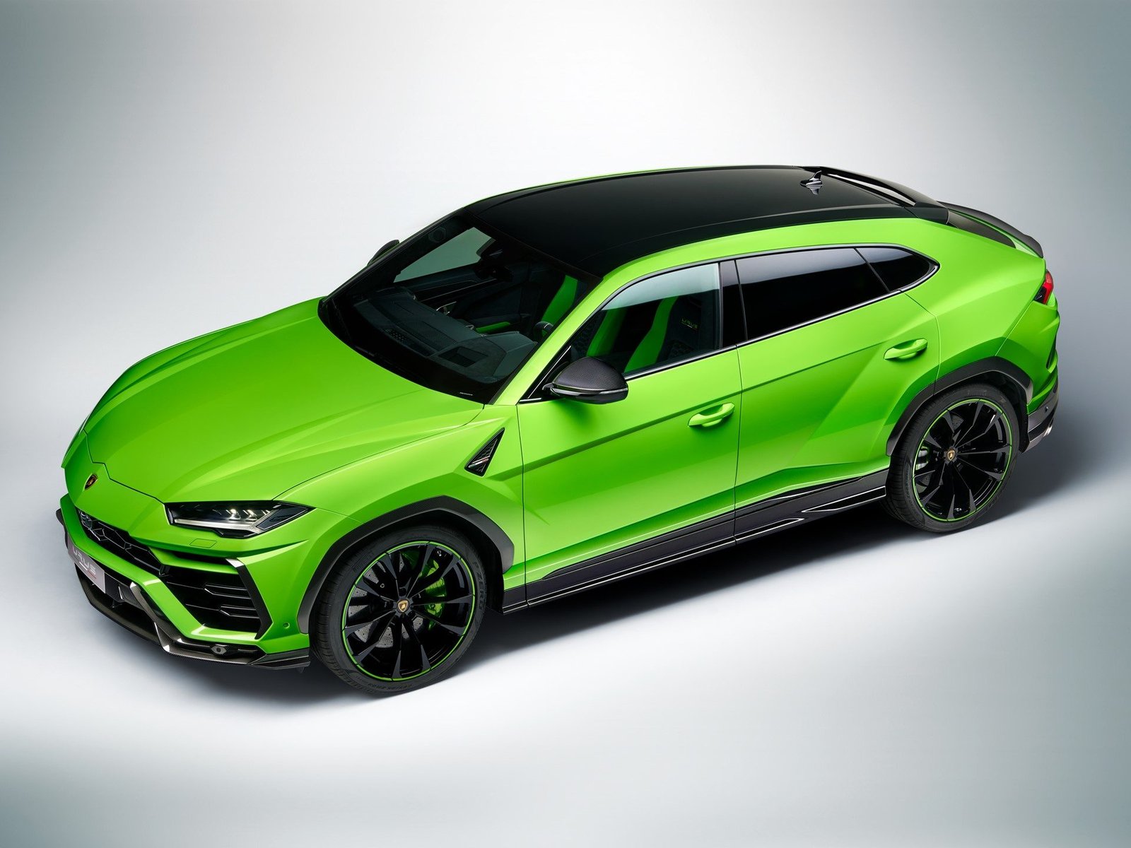 Overhead studio view of the Verde Mantis Lamborghini Urus Pearl Capsule showing gloss black roof and contrasting green pearl paint