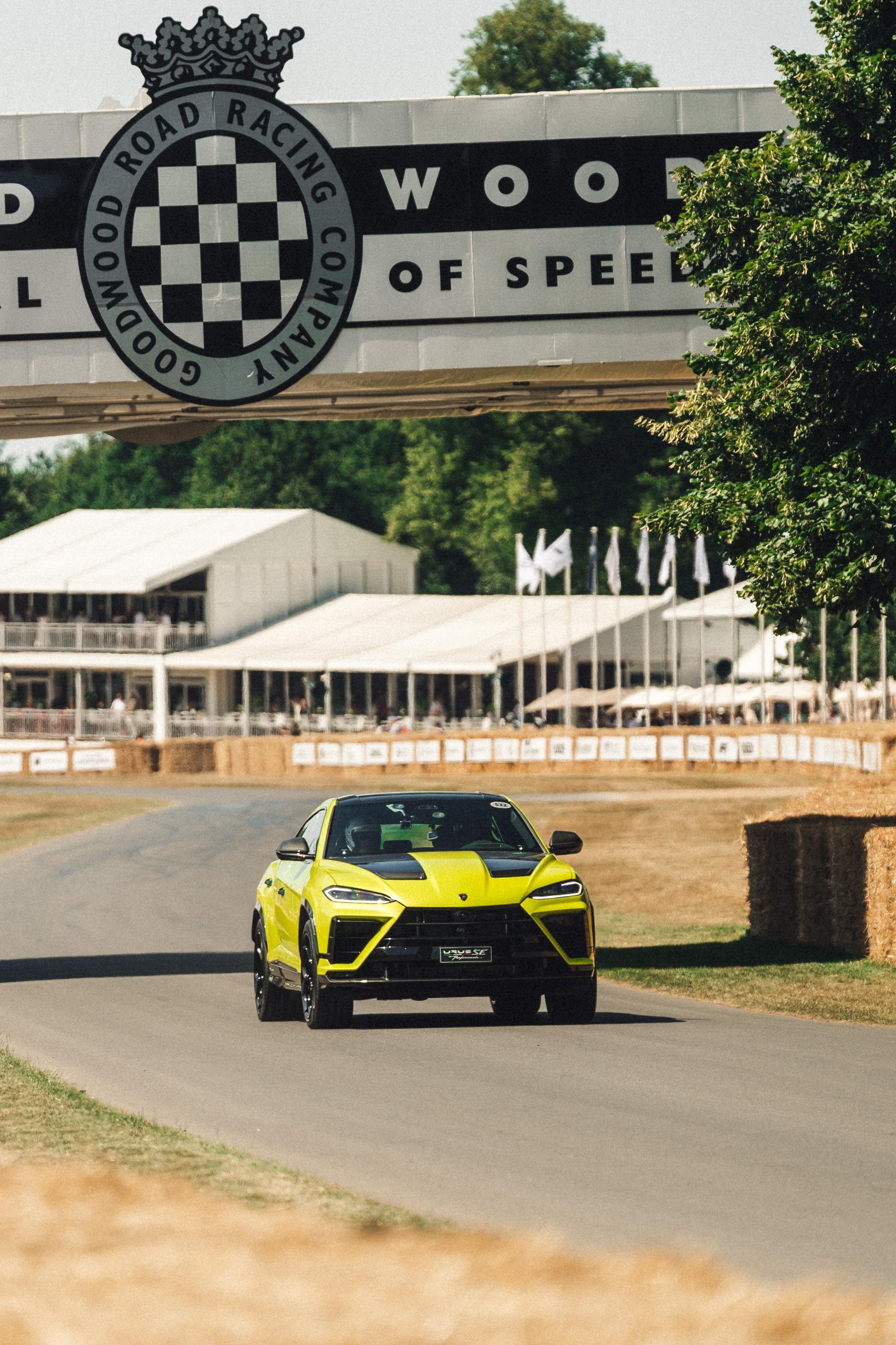 812 Hp In Verde Hydra: The Urus Se Performante Attacks Goodwood And Redefines What 'Performante' Means 3 Yellow and black lamborghini urus se driving under the goodwood road racing company bridge during the hill climb