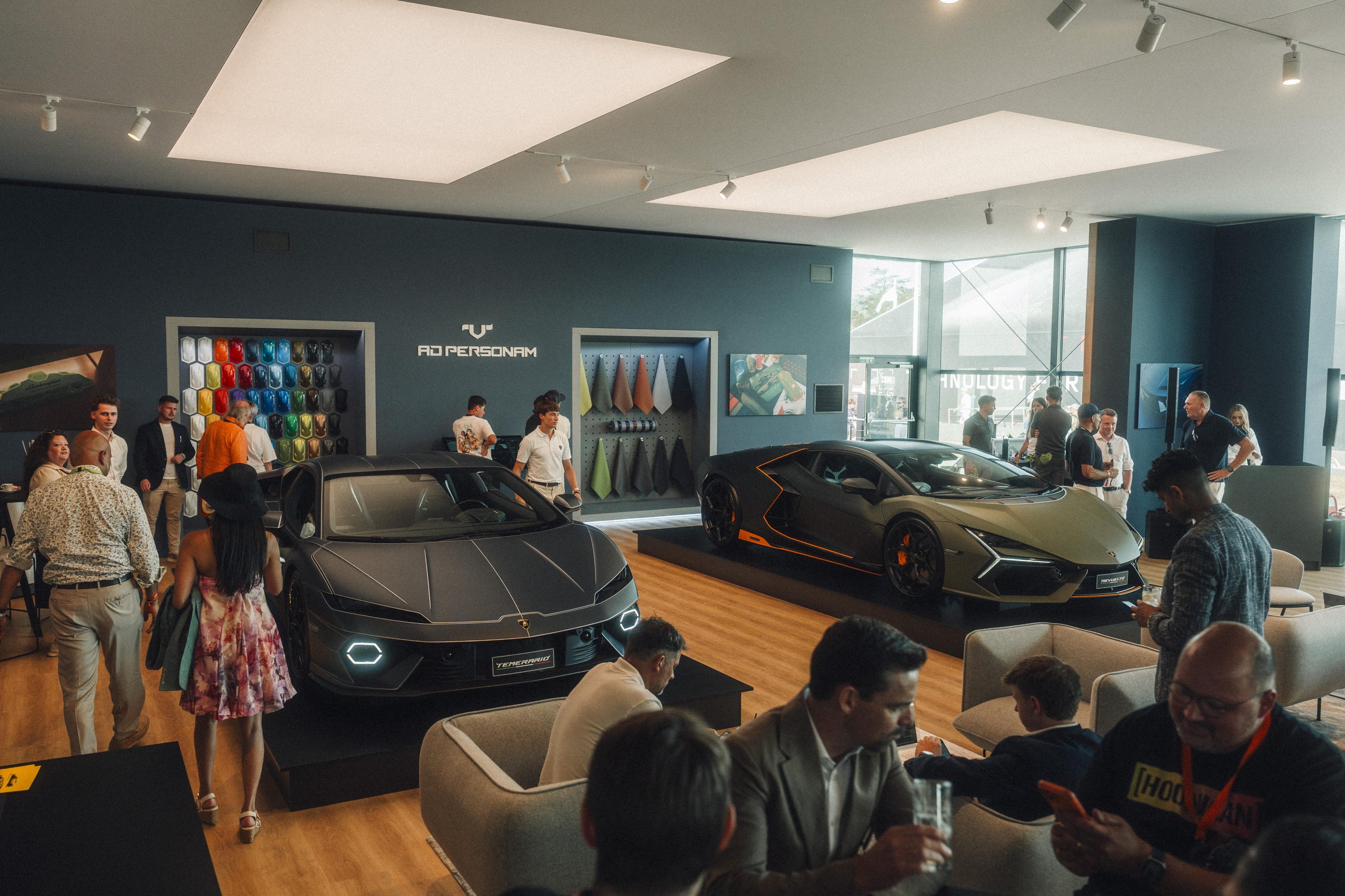 812 Hp In Verde Hydra: The Urus Se Performante Attacks Goodwood And Redefines What 'Performante' Means 7 Lamborghini temerario and revuelto displayed inside the ad personam lounge at goodwood with guests viewing the cars