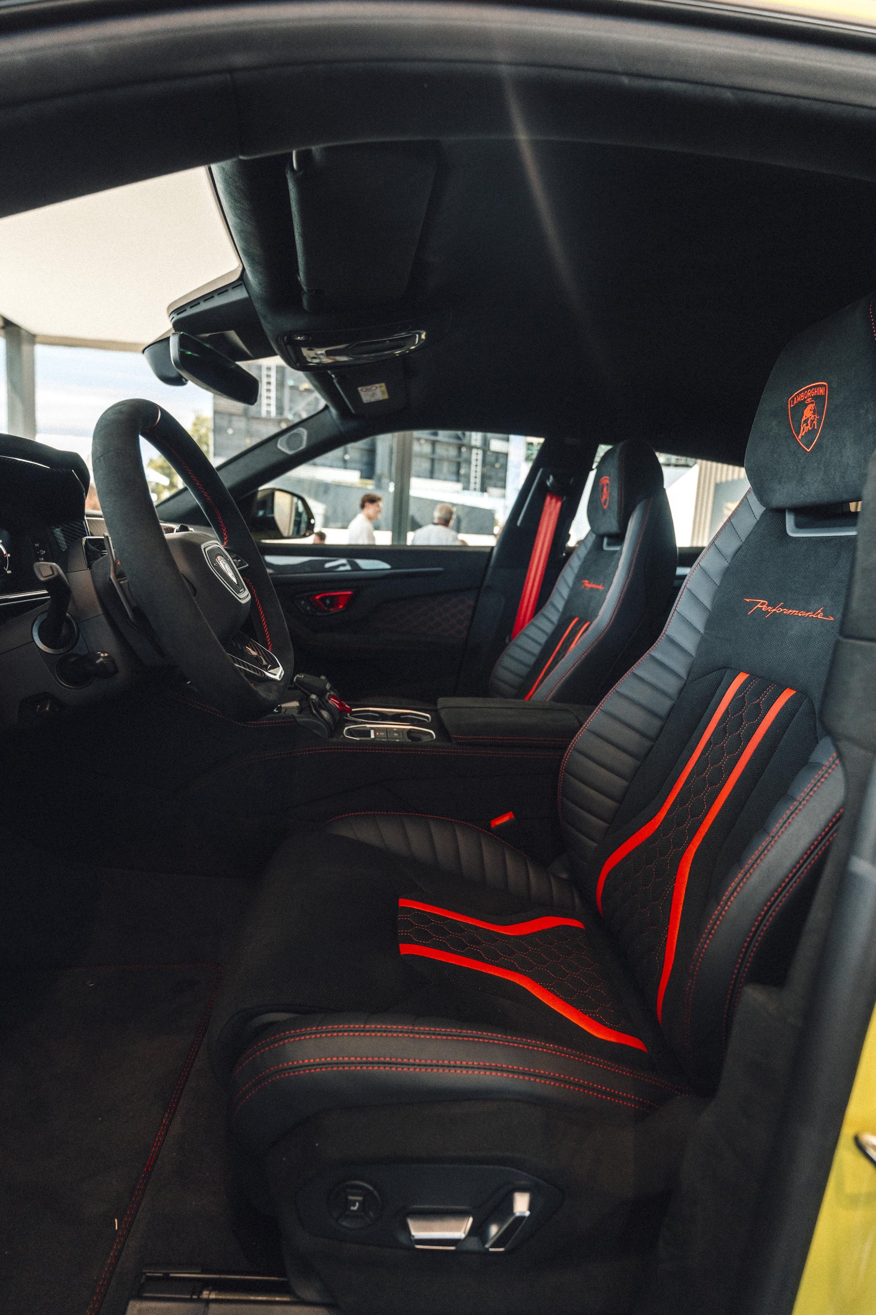 812 Hp In Verde Hydra: The Urus Se Performante Attacks Goodwood And Redefines What 'Performante' Means 13 Interior view of the lamborghini urus performante showing alcantara seats with red stitching, performante branding, and flat-bottom steering wheel