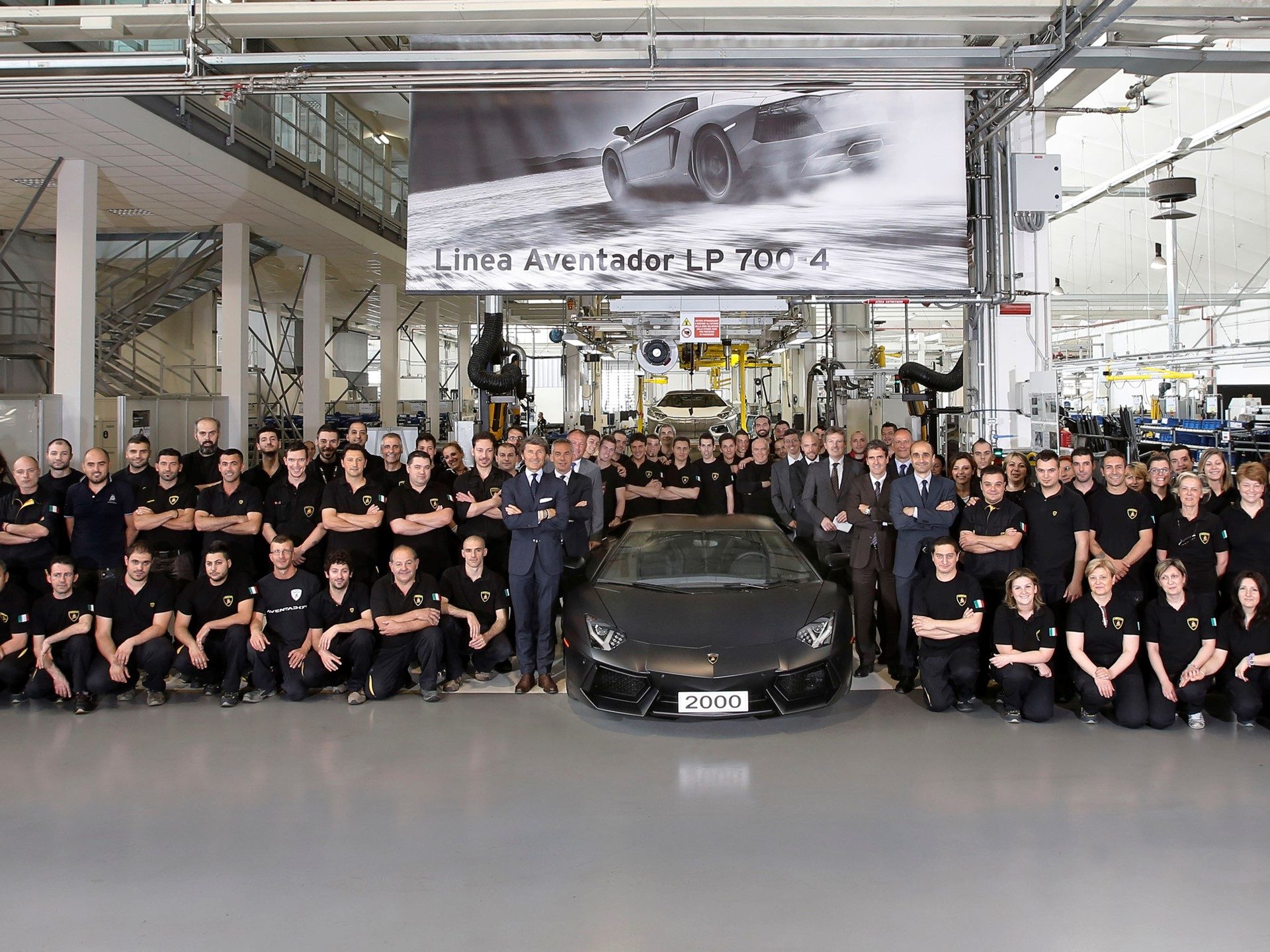 Lamborghini employees and executives pose with the matte black 2000th Aventador LP 700-4 on the Sant'Agata Bolognese factory floor