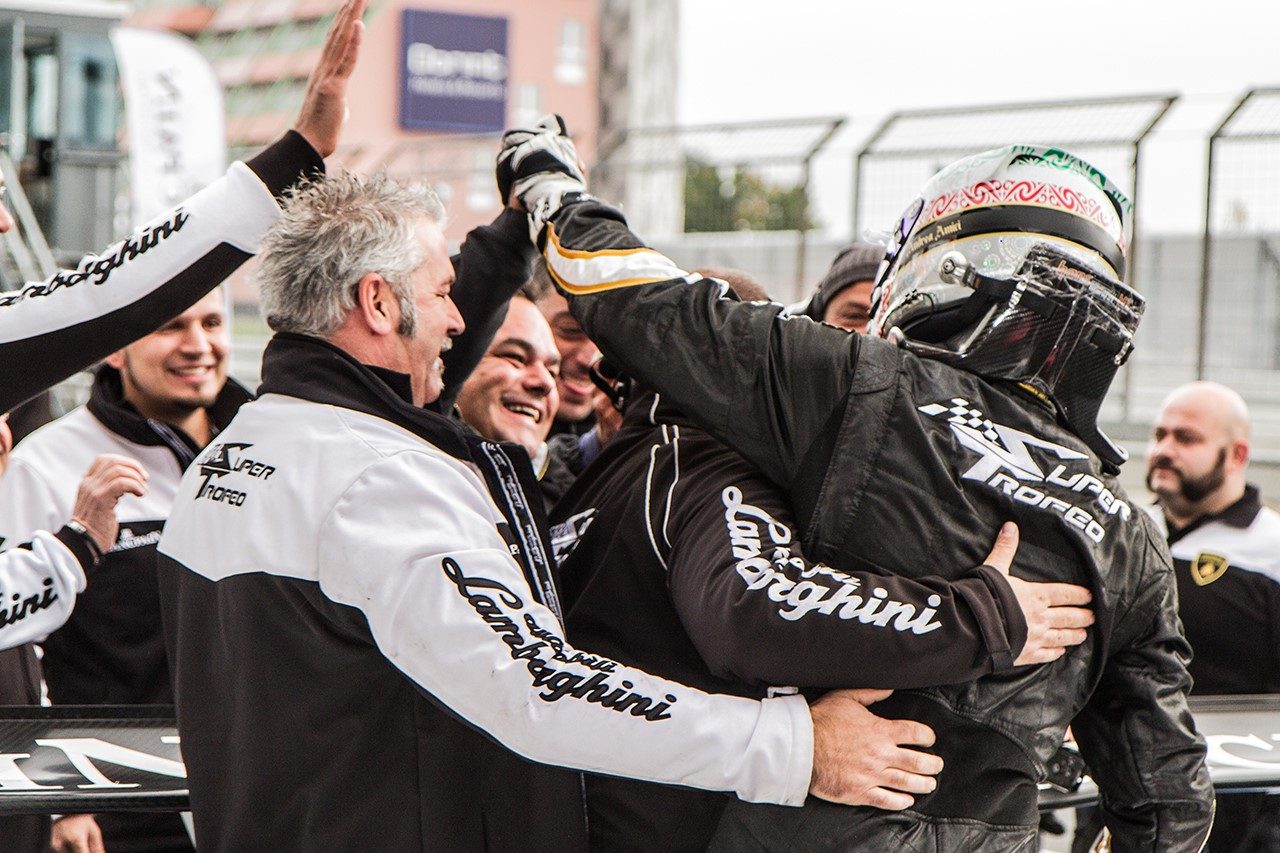 Andrea Amici celebrates his 2013 Lamborghini Blancpain Super Trofeo PRO-AM championship with team members at the track