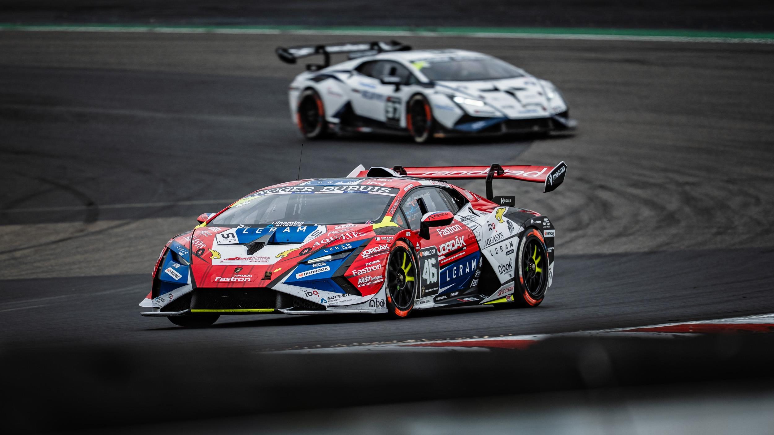 Two Lamborghini Huracán Super Trofeo EVO2 race cars in close formation on the Nürburgring circuit