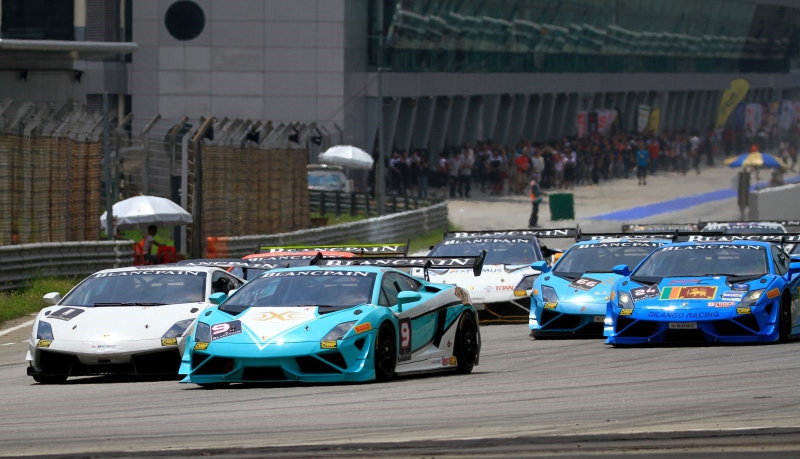 Gallardo Super Trofeo cars racing in close formation at Sepang, showing aerodynamic body kits and large rear wings