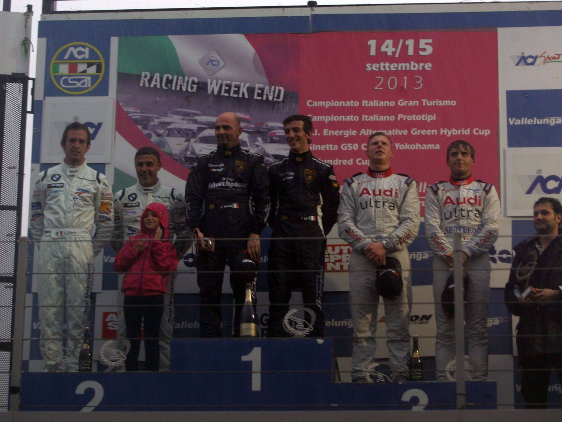 Podium celebration after Lamborghini's maiden 2013 Campionato Italiano Gran Turismo win at Vallelunga, with race car drivers and team members