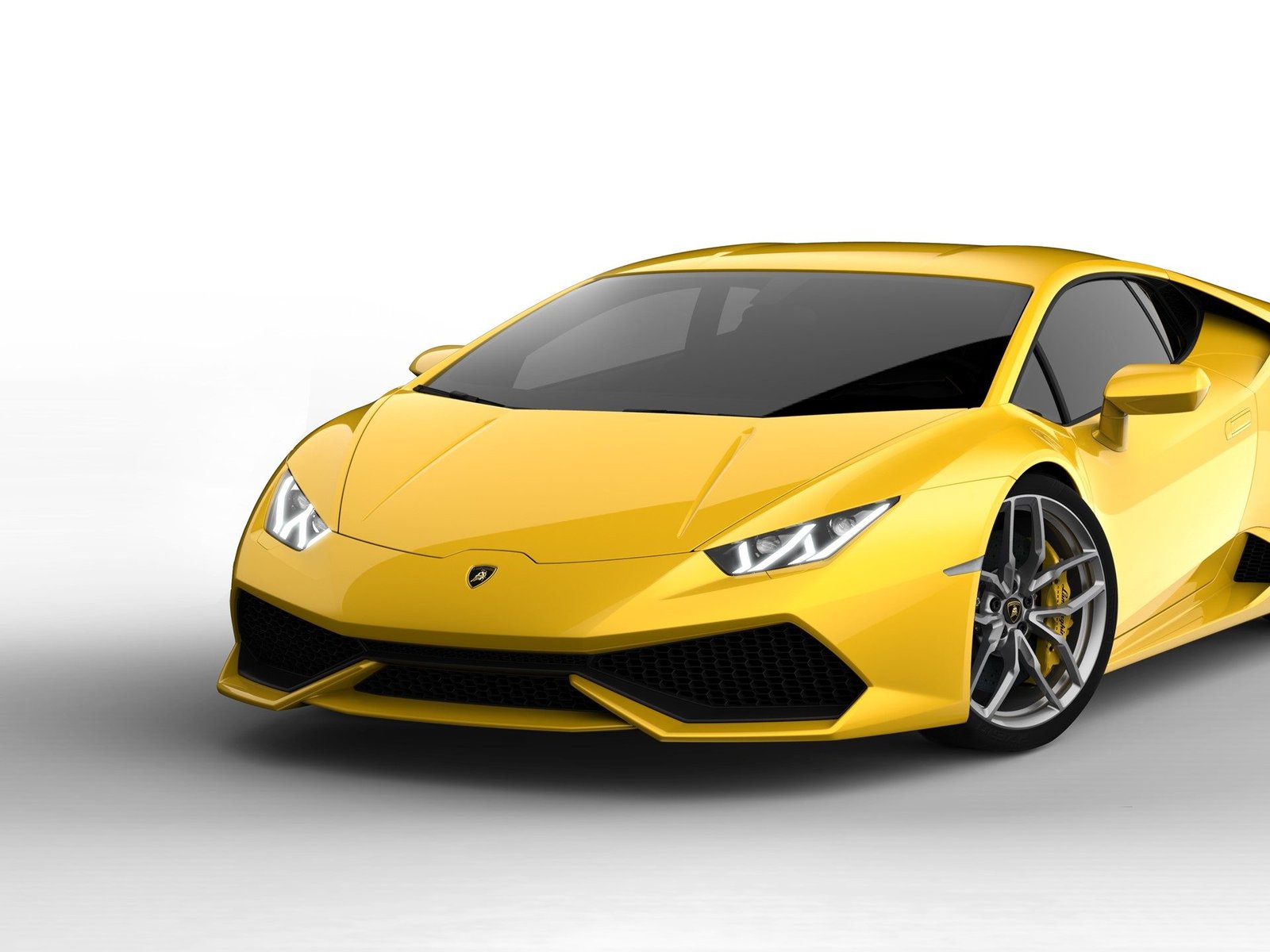 Bright yellow Lamborghini Huracán LP 610-4 in a studio setting, showcasing its sharp angular bodywork and Y-shaped LED daytime running lights