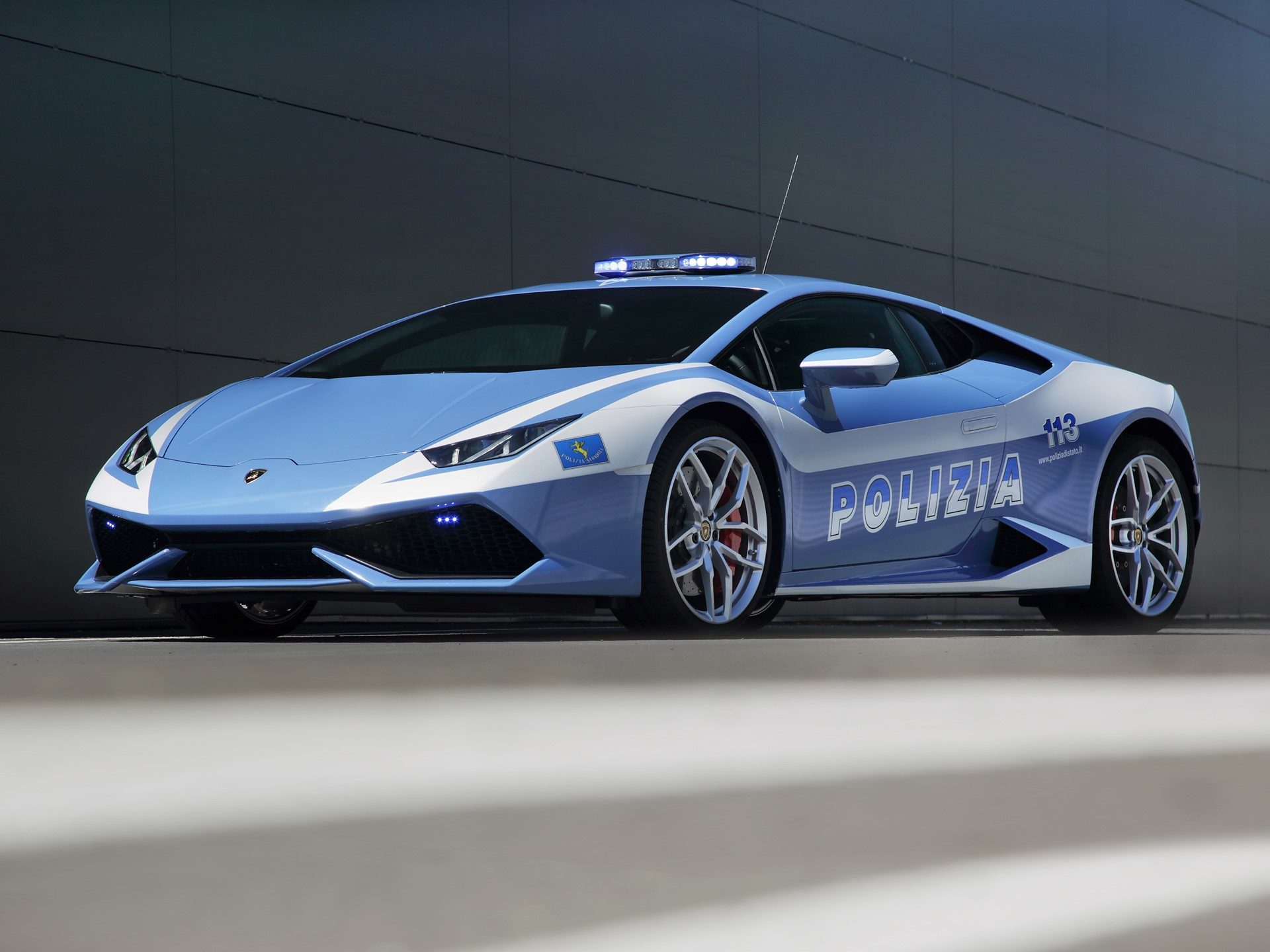 Light blue and white Lamborghini Huracán LP 610-4 Polizia with Italian State Police livery, emergency lights, and communication antenna