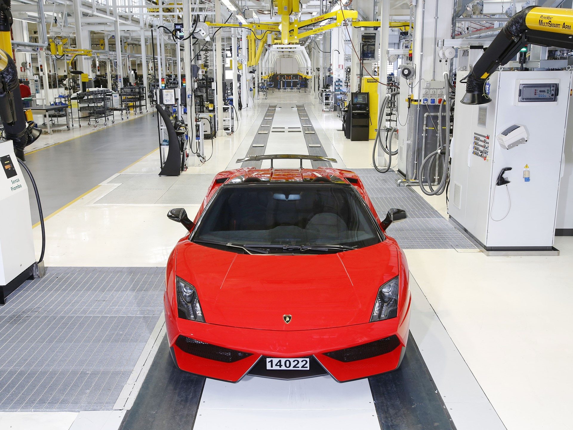 Red Lamborghini Gallardo on the factory production line showing its aggressive front fascia and rear wing