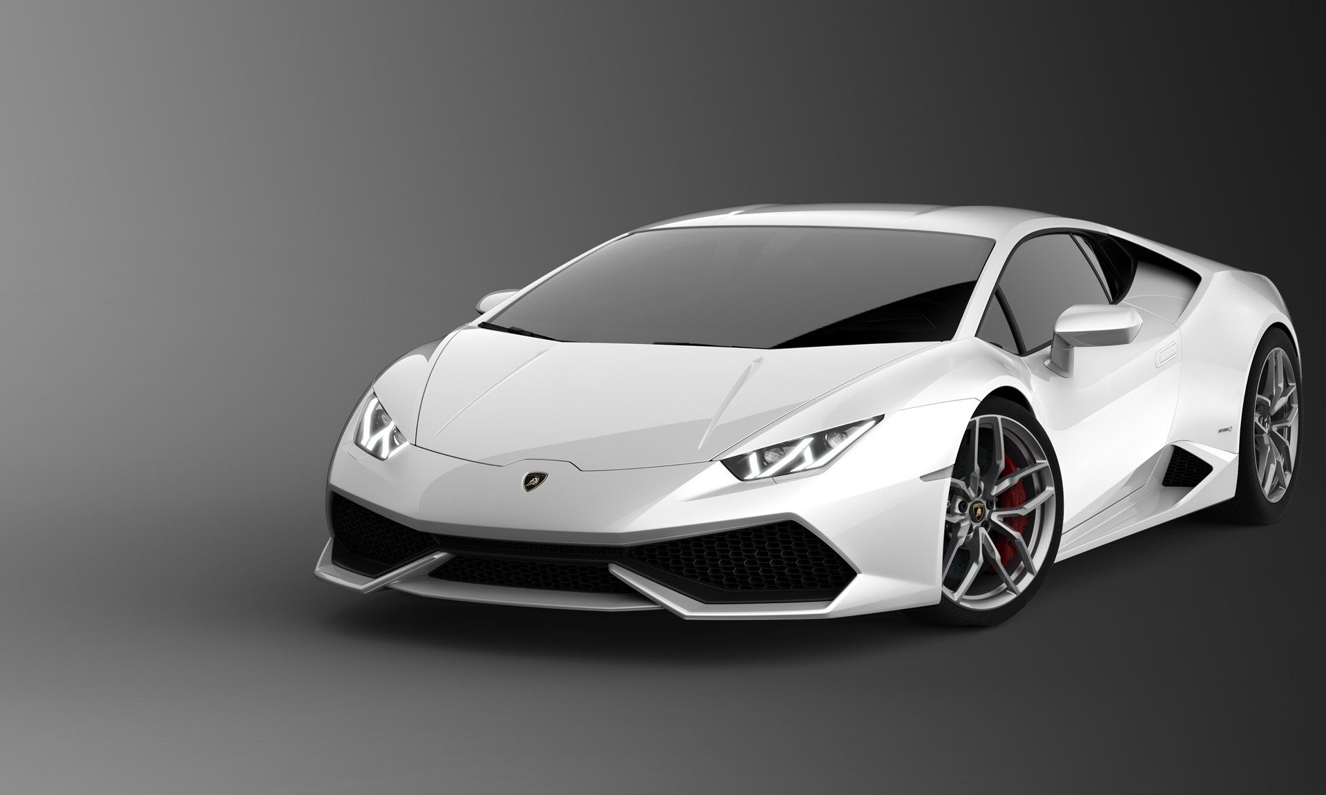 White Lamborghini Huracán LP 610-4 in a studio setting, showcasing its sharp lines, hexagonal grille, and Y-shaped LED daytime running lights