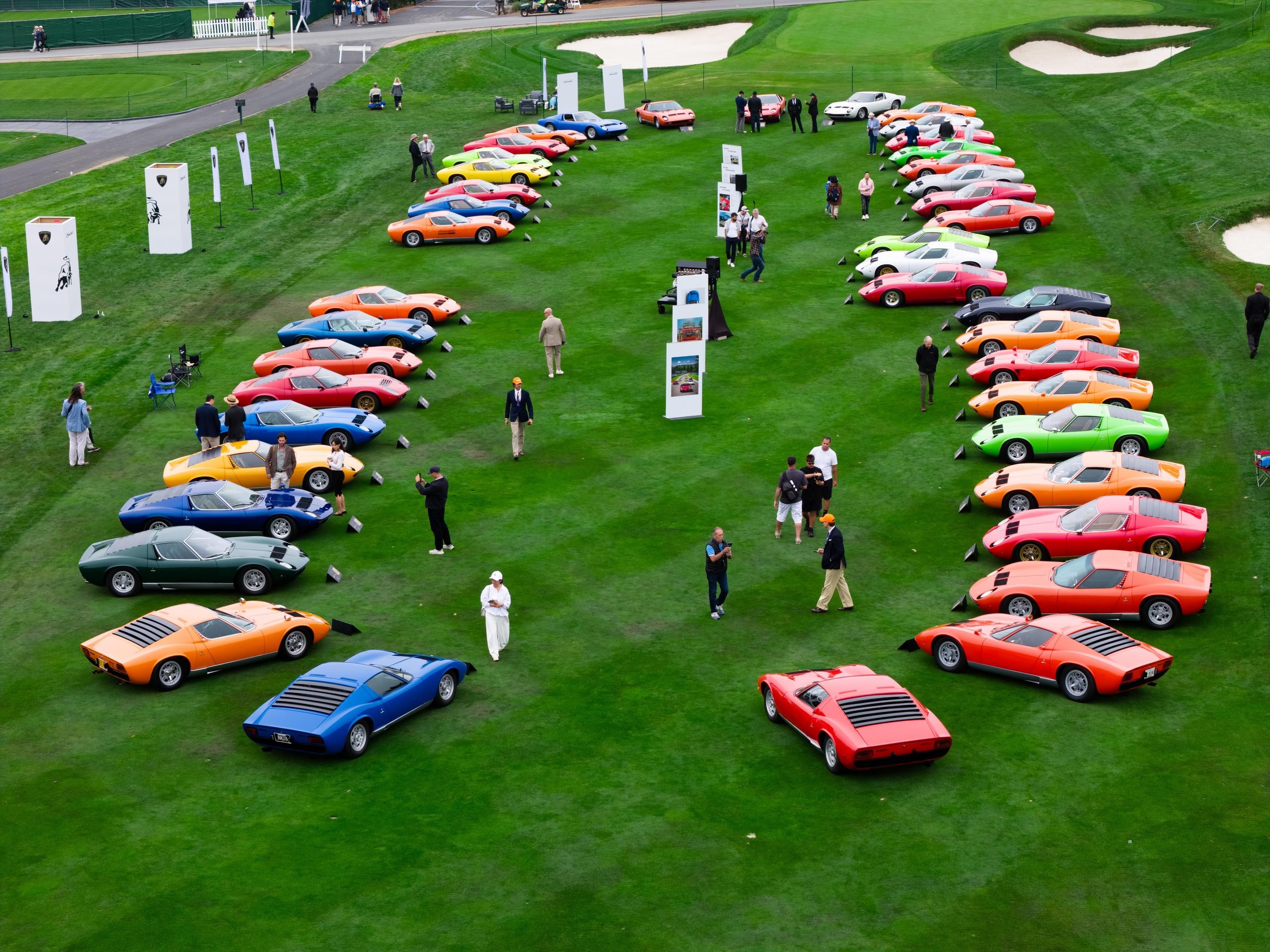 Aerial view of 43 Lamborghini Miuras in assorted colors displayed on the third fairway at Pebble Beach during Monterey Car Week 2026