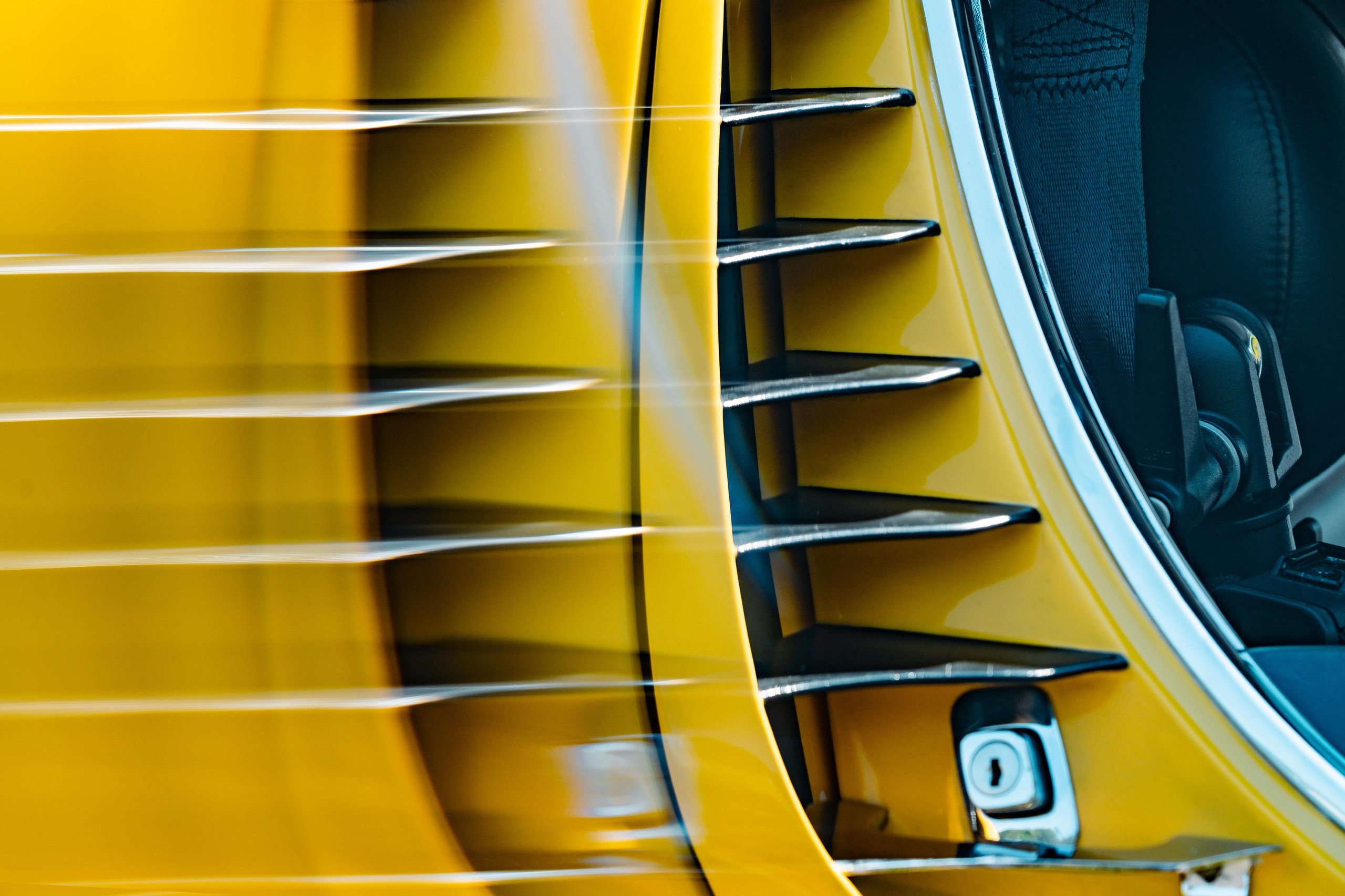 Lamborghini'S Miura Sv At 55: Why An Astronaut Behind The Wheel Says More Than Any Spec Sheet 7 Close-up of the yellow lamborghini miura sv side vents and body lines with motion blur