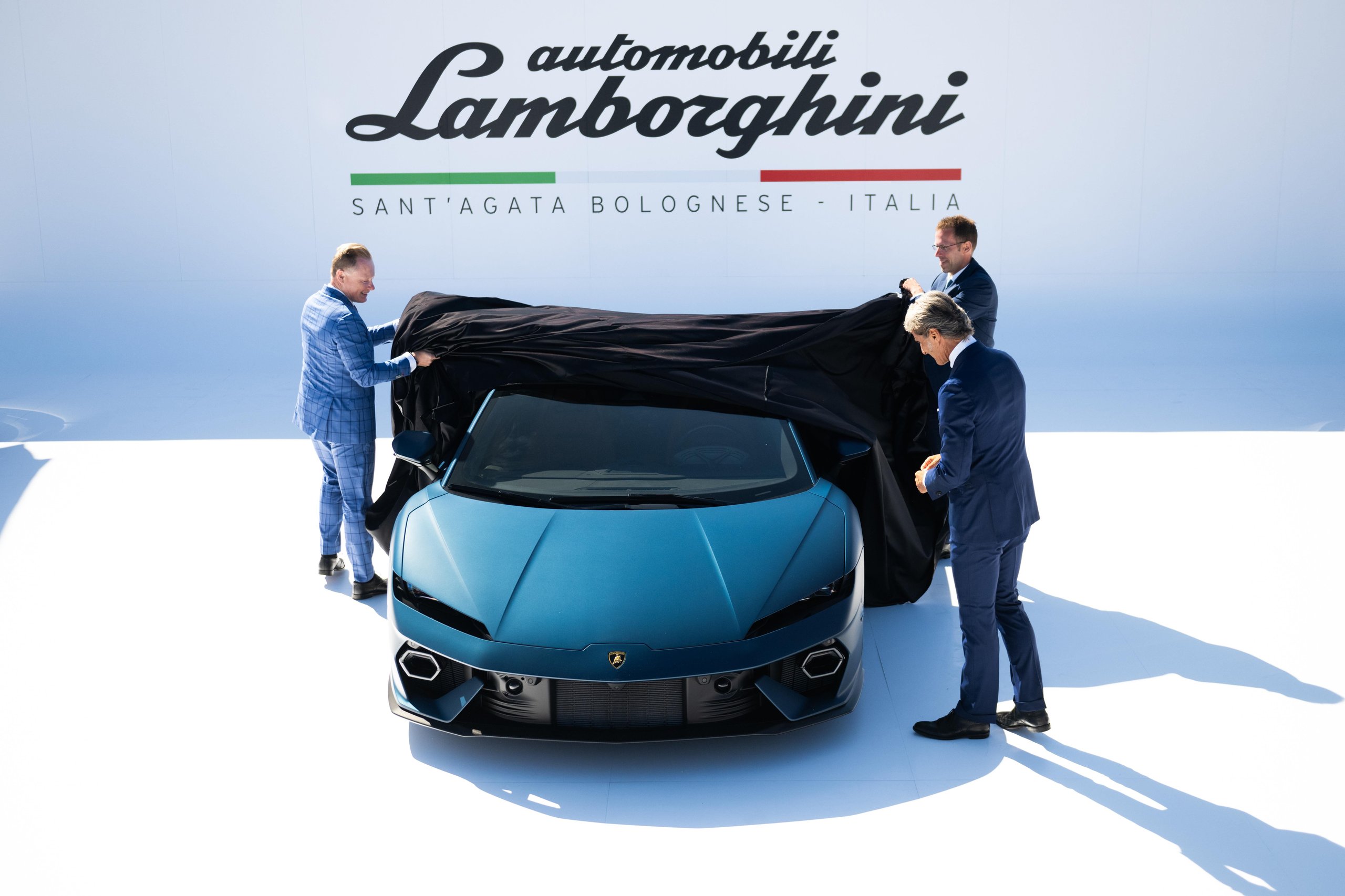 Lamborghini executives unveil the matte blue Temerario at its Monterey Car Week 2024 world premiere, pulling a black cover off the car