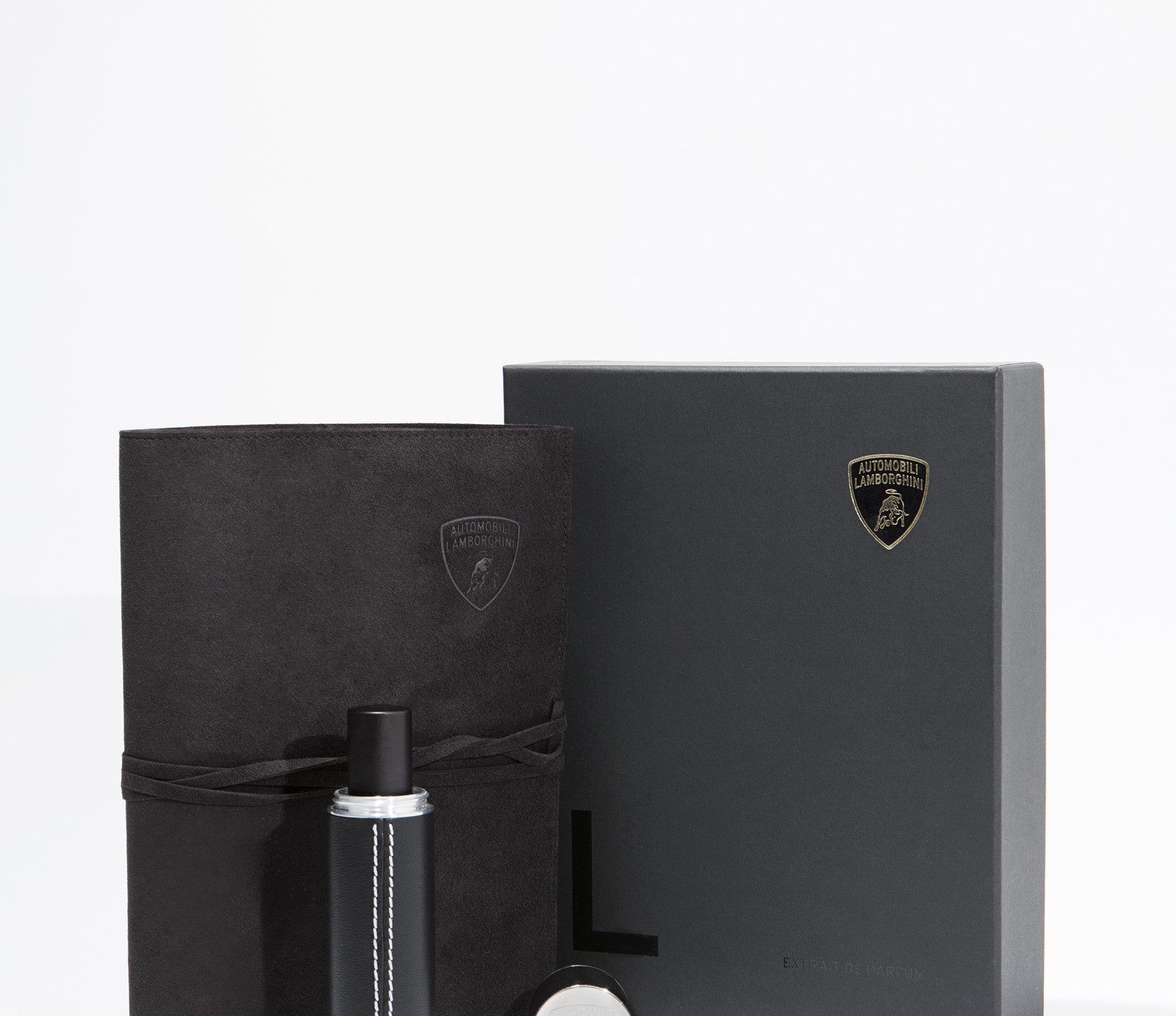 Close-up of the Lamborghini L Extrait de Parfum black bottle with gold Lamborghini logo on presentation box
