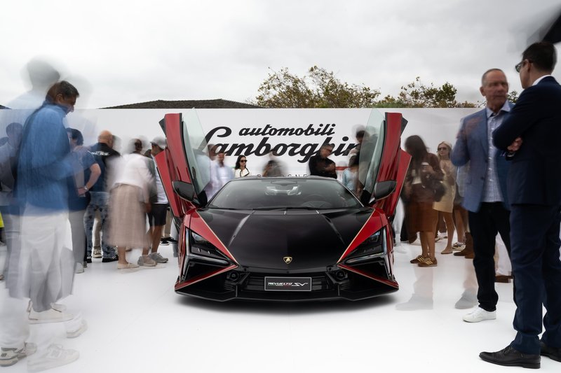 Black and red Lamborghini Revuelto SV with scissor doors open at The Quail during Monterey Car Week