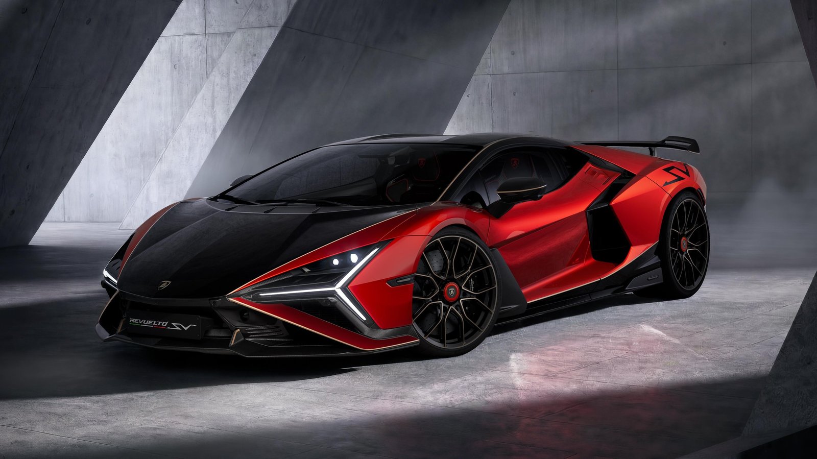 Red and black Lamborghini Revuelto SV in a studio, showcasing aggressive aerodynamic design and two-tone paint
