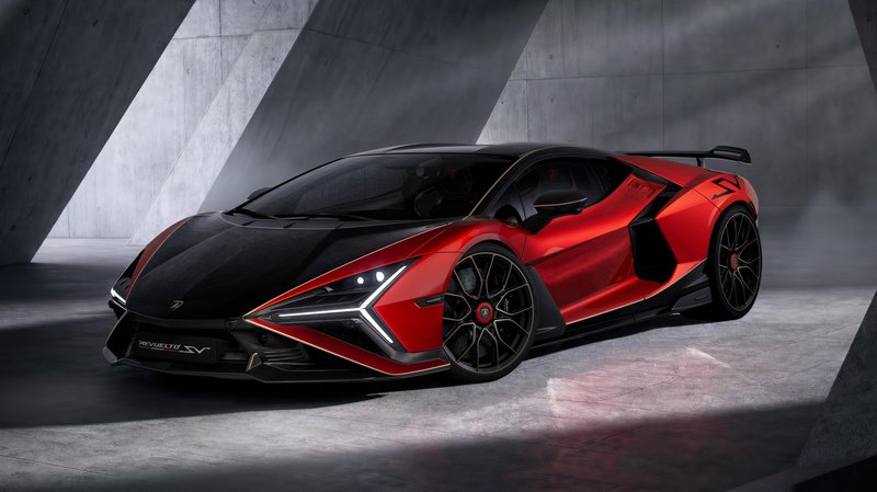 Red and black Lamborghini Revuelto SV in a studio, showcasing aggressive aerodynamic design and two-tone paint