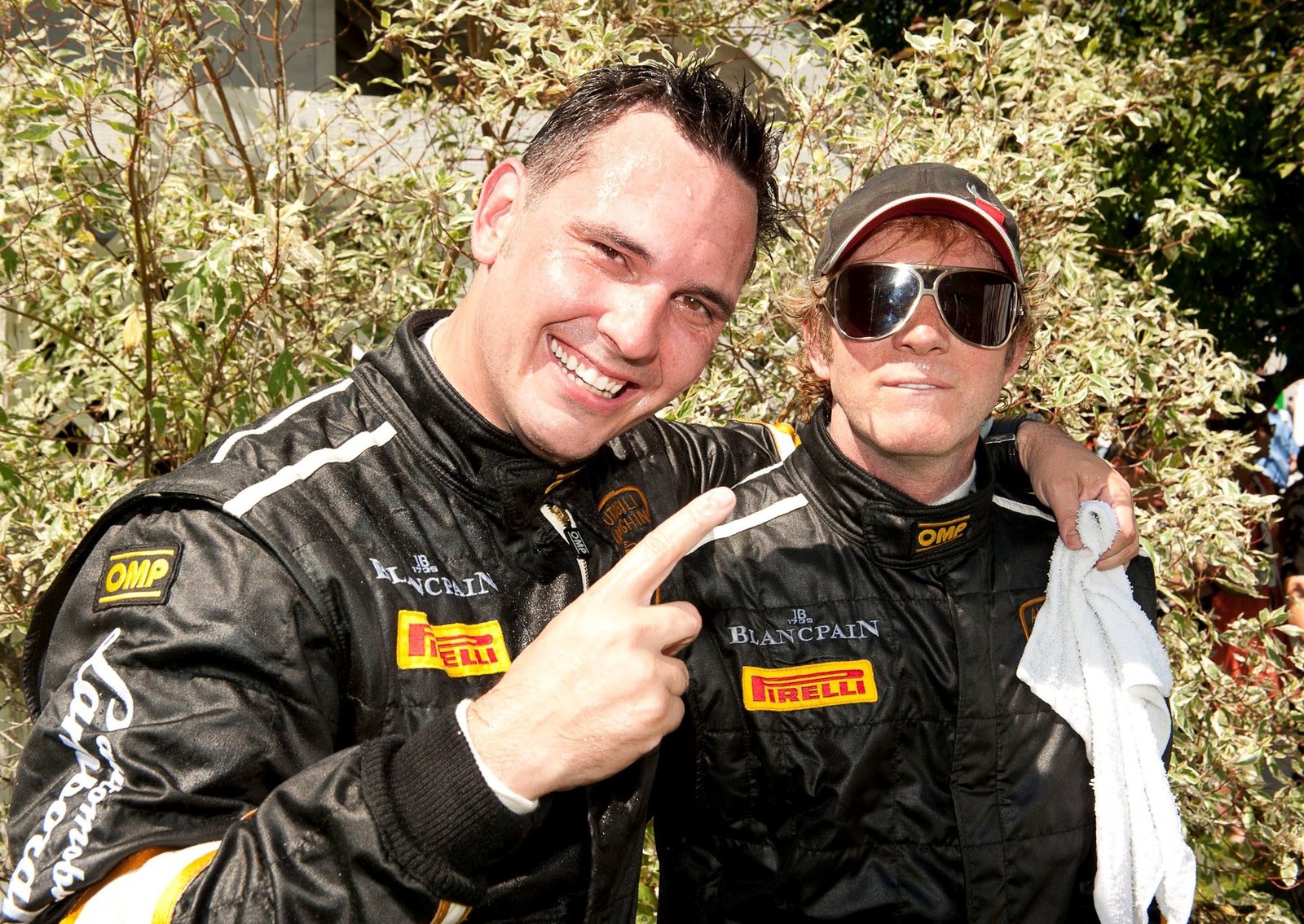 Two Lamborghini Super Trofeo team members in black racing suits at the inaugural North American race