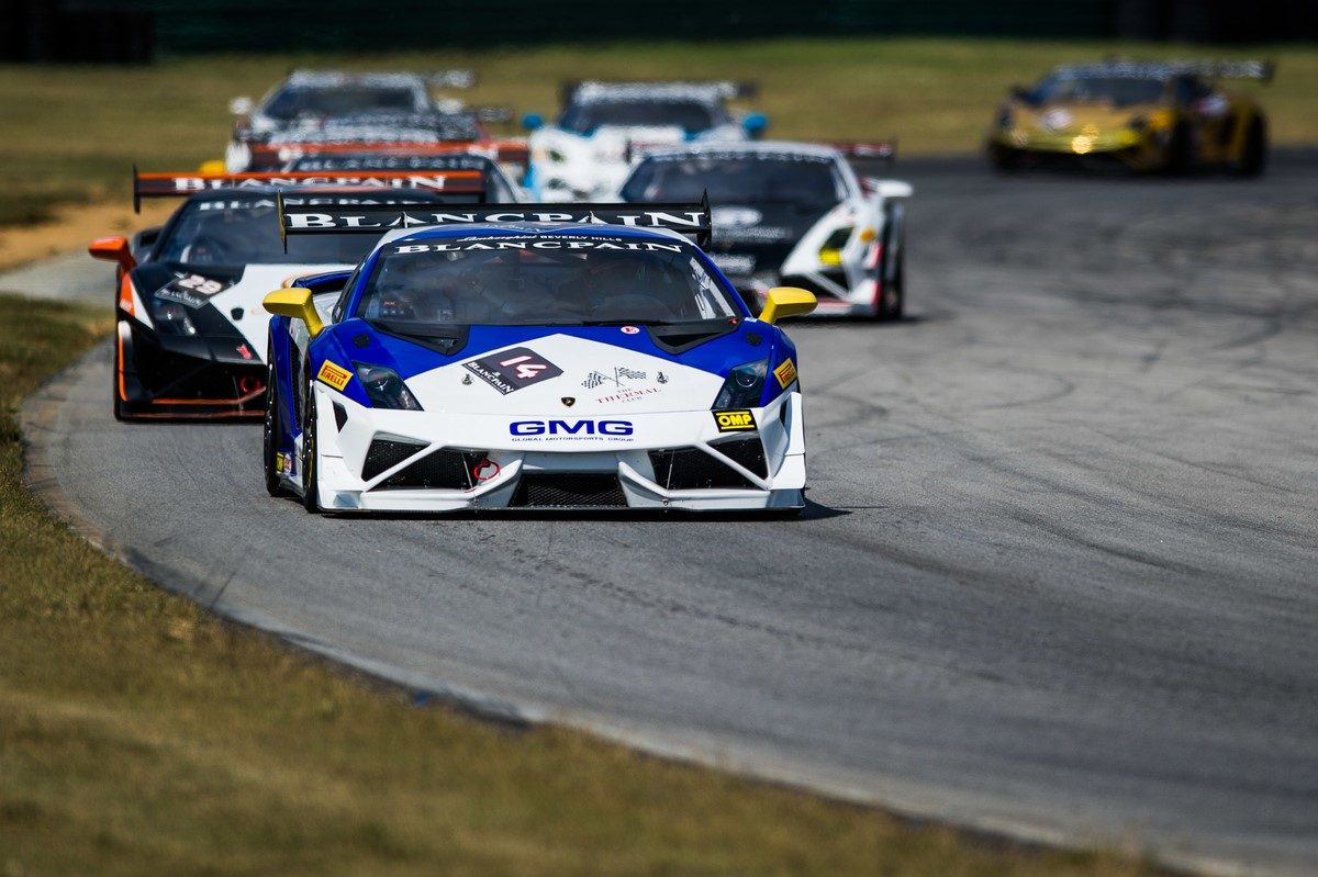 Lamborghini Gallardo Super Trofeo race car leading a pack of competitors on track during the 2013 North American season
