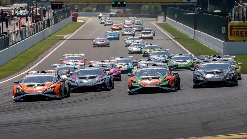 A pack of Lamborghini Huracán Super Trofeo EVO2 race cars in diverse liveries racing closely on track during the Super Trofeo Europe championship