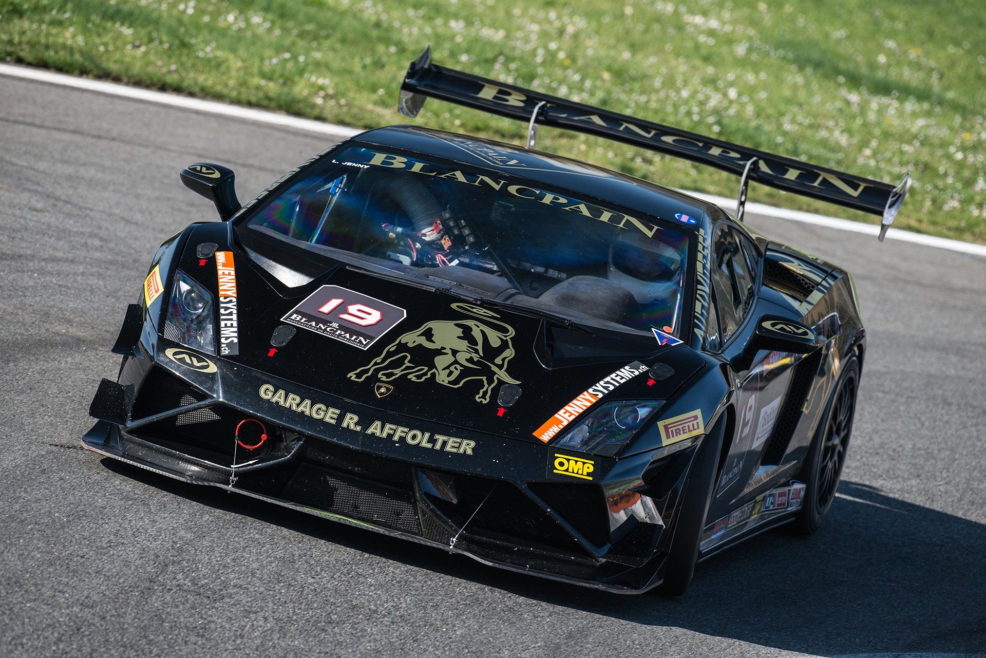 Black Lamborghini Gallardo Super Trofeo race car with gold accents and Blancpain livery on track