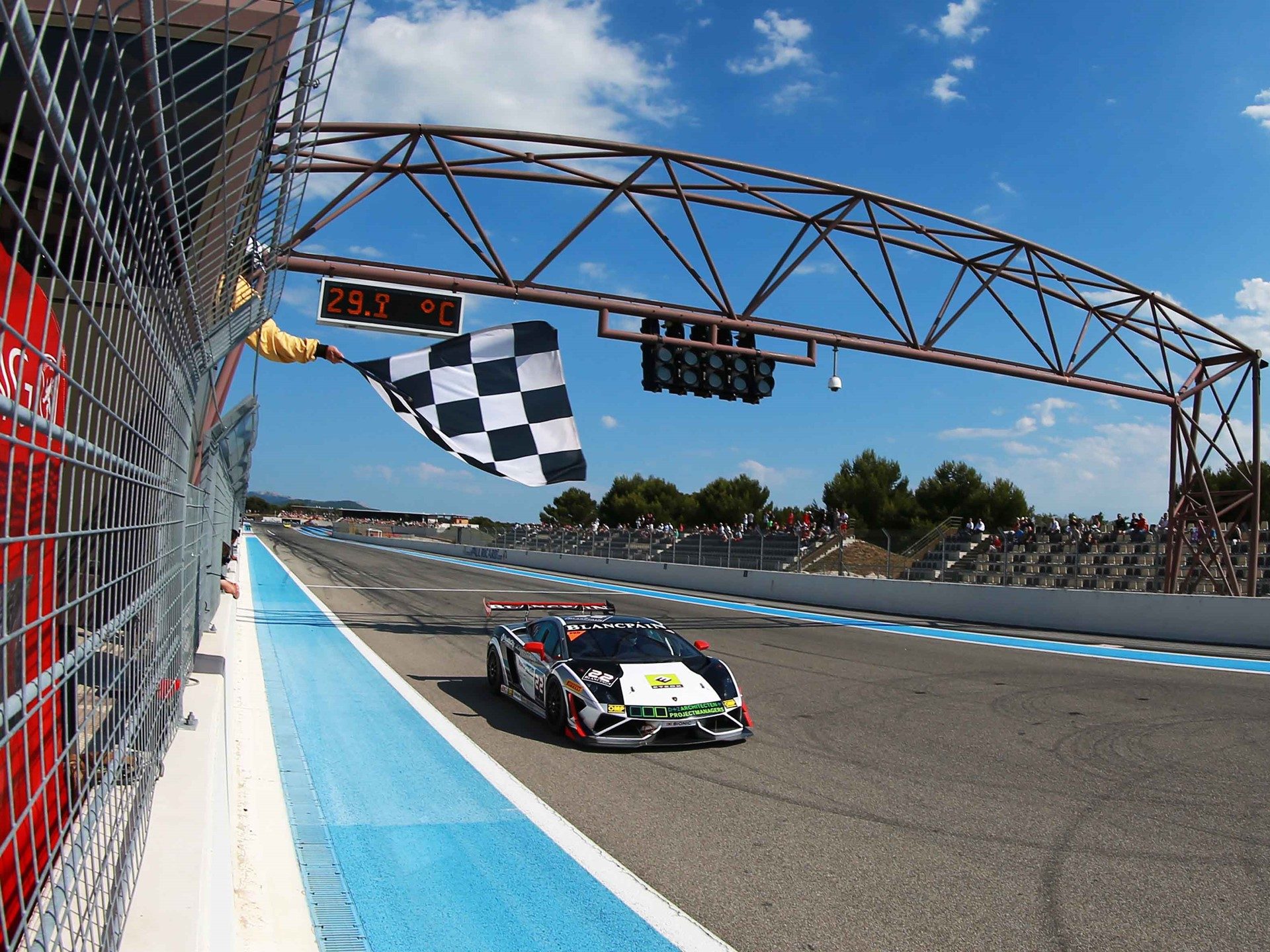 A Lamborghini Gallardo Super Trofeo race car takes the checkered flag at Paul Ricard in 2014
