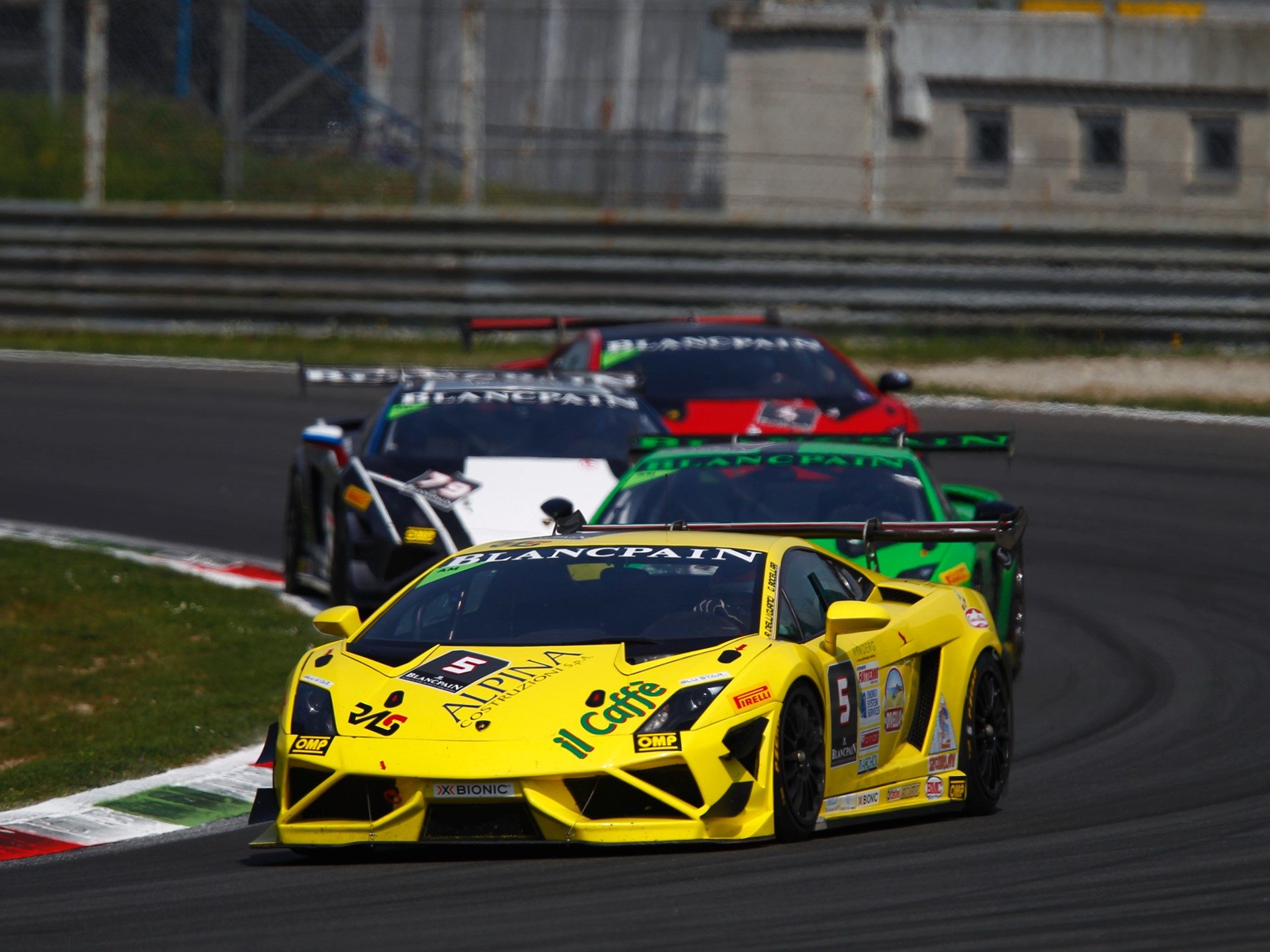 A yellow Lamborghini Gallardo Super Trofeo race car leads a pack of competitors on track at the 2014 Blancpain Super Trofeo season opener