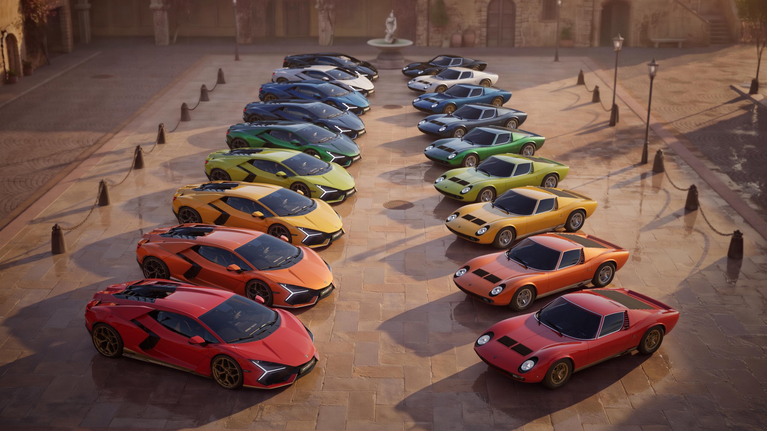 99 Units, Nine Heritage Colors, And One Very Specific Invitation: Inside The Revuelto Miura 60° Homage 3 Multiple lamborghini revuelto and miura models in various heritage colors arranged in rows on a cobblestone plaza