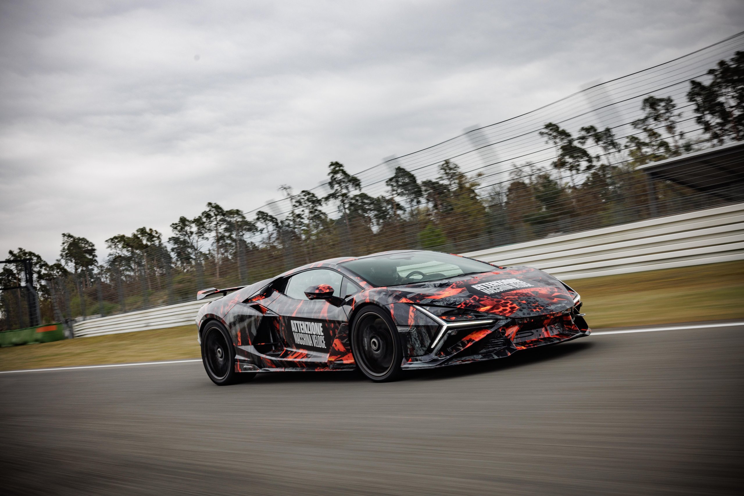 Side profile of the Lamborghini Revuelto SV prototype at speed showing sleek lines and large rear wing