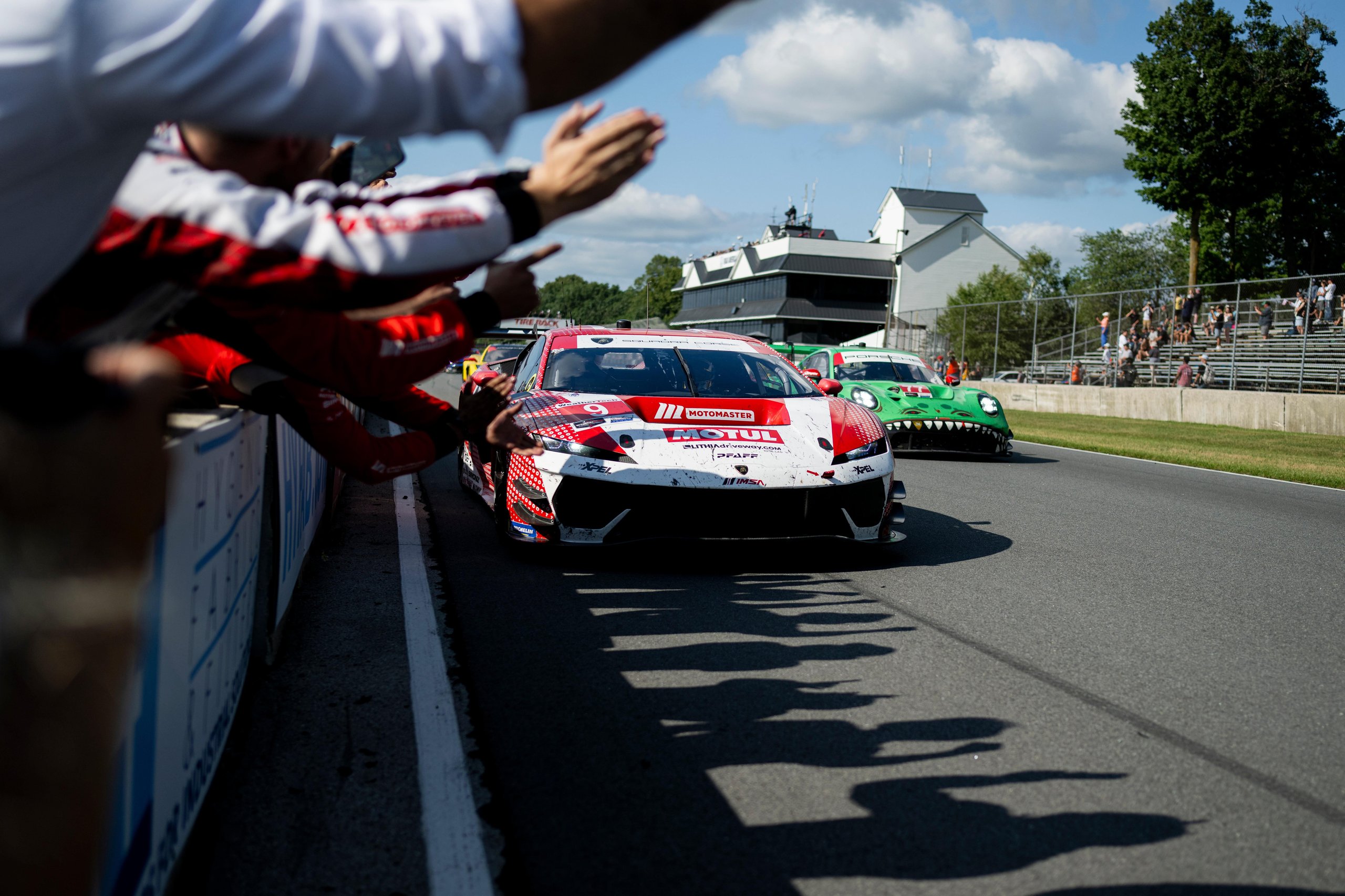 Temerario Gt3 Wins First Imsa Endurance Race At Road America, Five Months After Its Debut 3 The red and white lamborghini temerario gt3 race car passes cheering fans at road america during the imsa six-hour endurance race