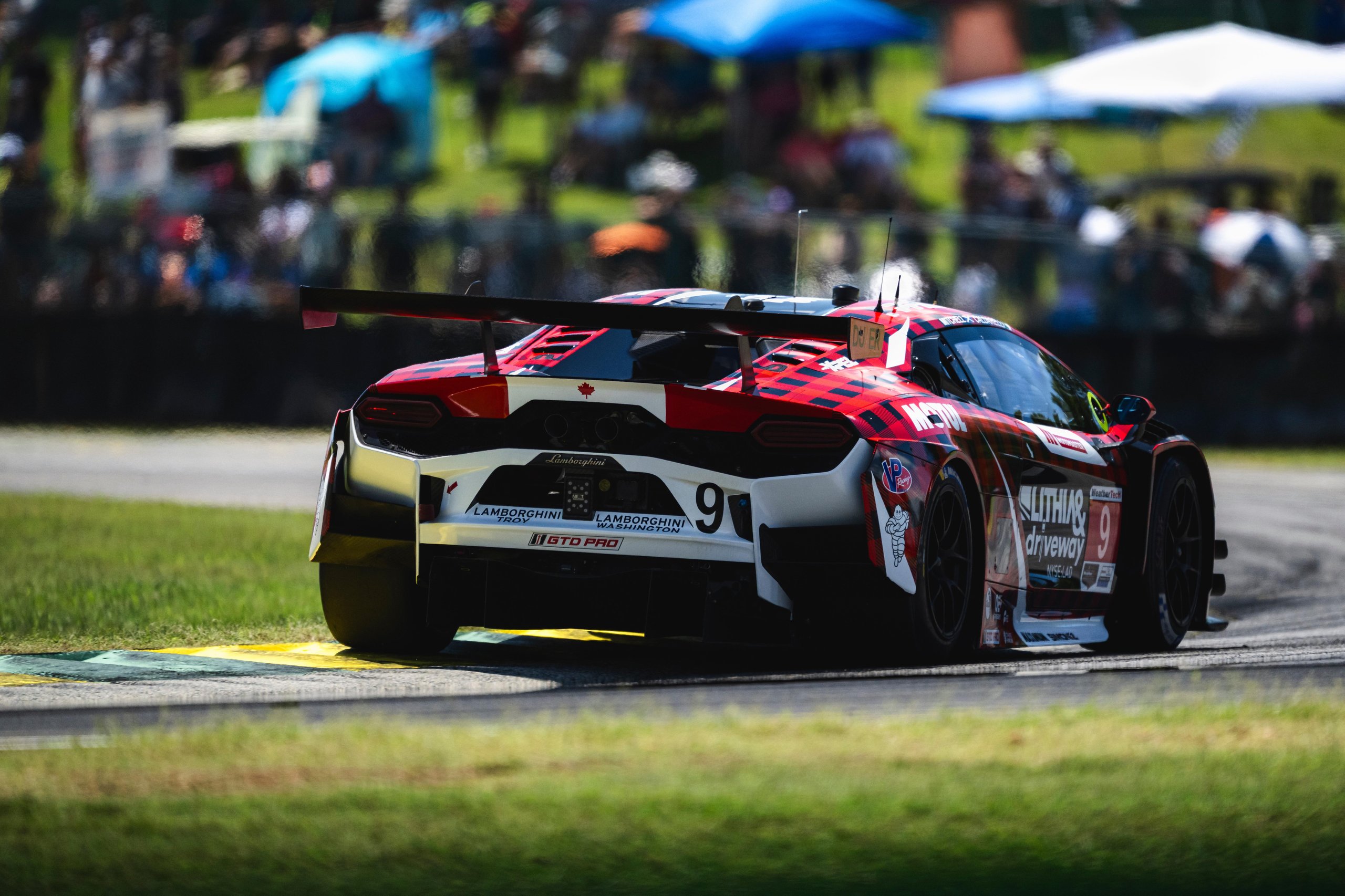 Rear view of the Lamborghini Temerario GT3 showing its rear diffuser, wing, and exhaust layout on track at VIR
