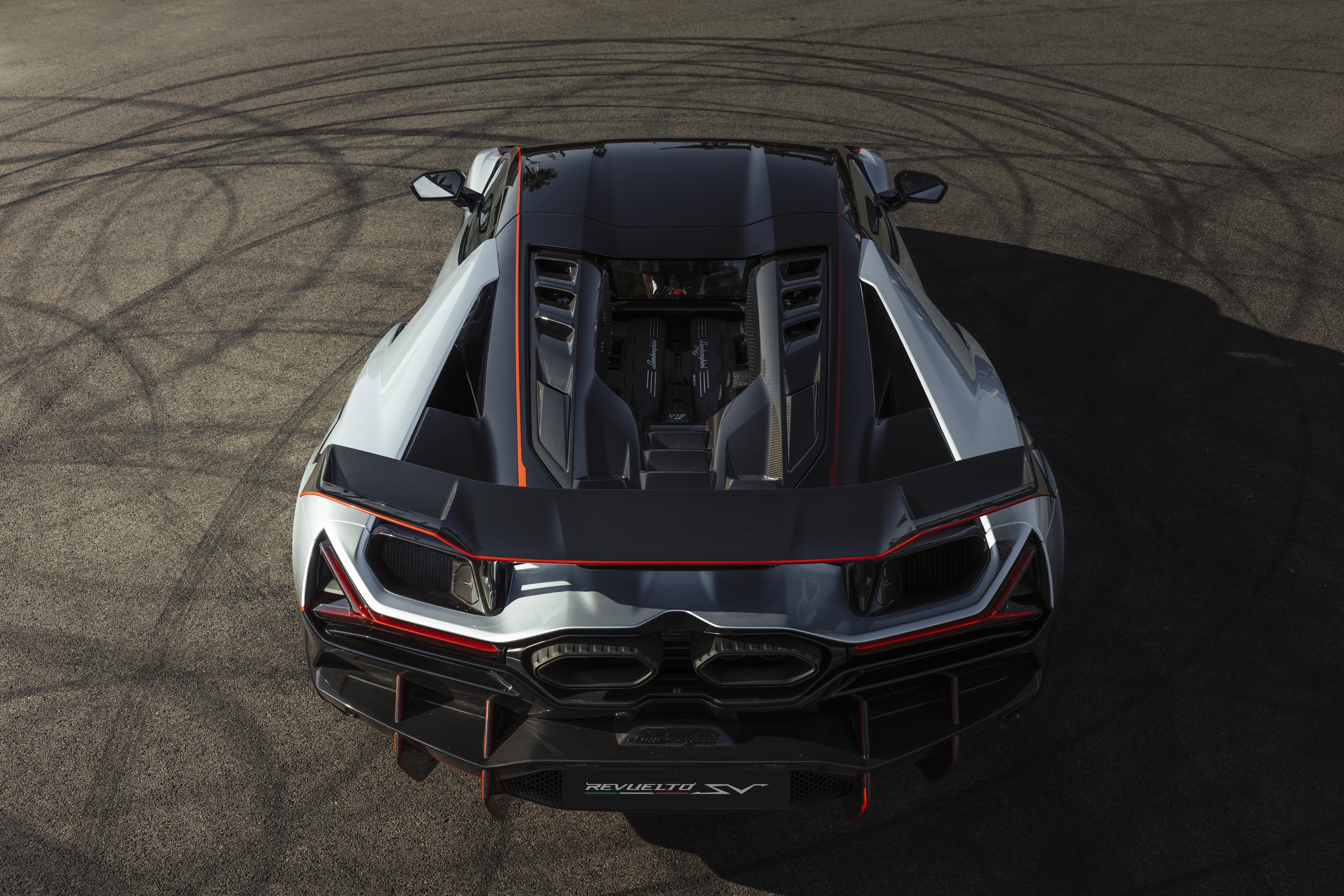 Overhead rear view of grey and black Lamborghini Revuelto SV on track with tire marks, showing exposed engine bay and carbon fiber details