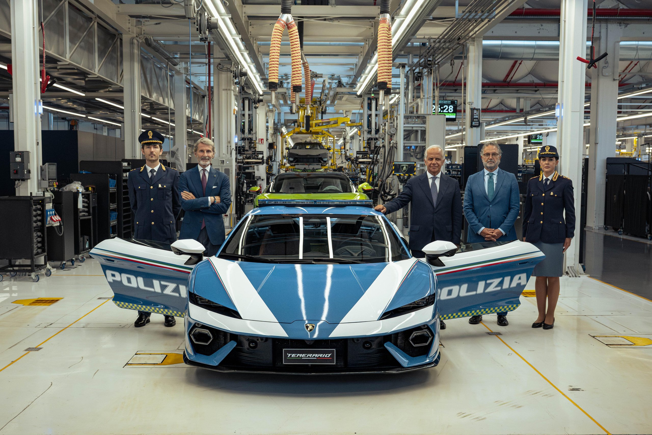 Blue and white Lamborghini Temerario Polizia displayed at Sant'Agata Bolognese headquarters with police officers and Lamborghini executives